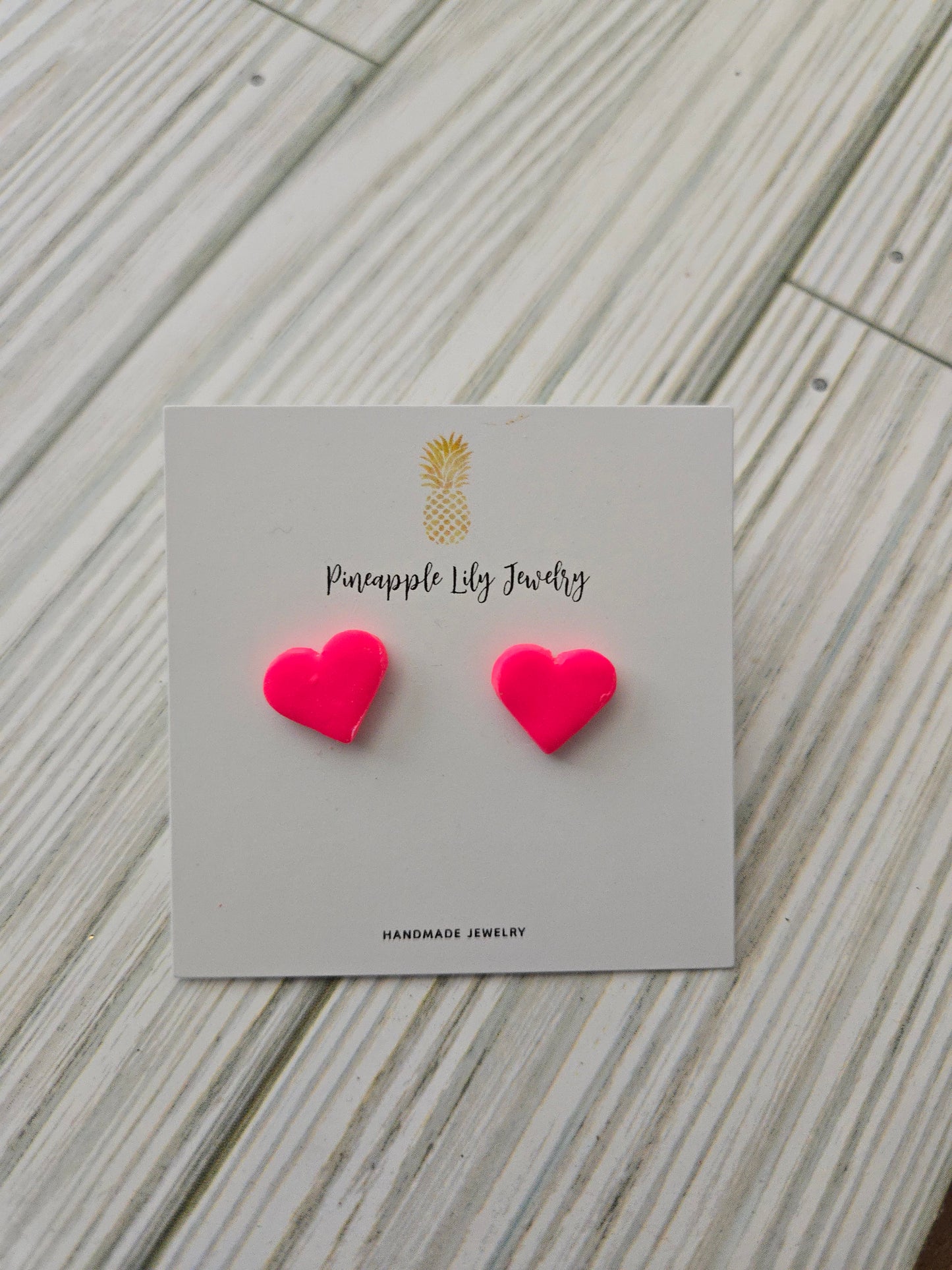 Bright pink heart studs